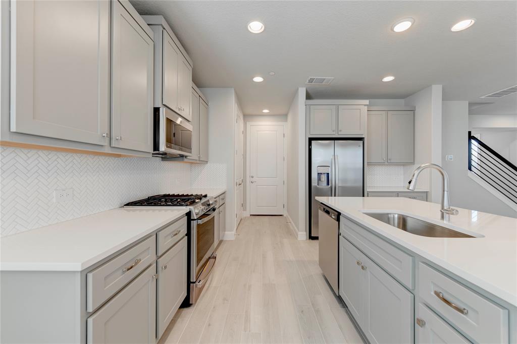 2605 Sam Bass Road, Unit 91 Round Rock, TX 78681 - Photo 11 of 32 a kitchen with a sink stove and refrigerator
