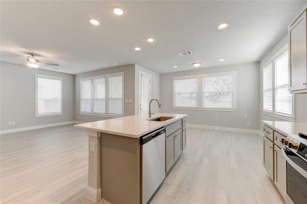 2605 Sam Bass Road, Unit 91 Round Rock, TX 78681 - Photo 12 of 32 a kitchen with granite countertop a sink and a stove top oven