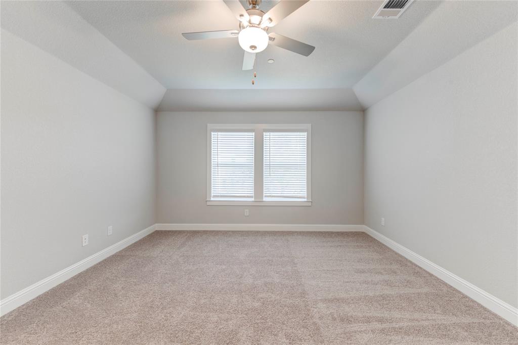 2605 Sam Bass Road, Unit 91 Round Rock, TX 78681 - Photo 23 of 32 an empty room with a chandelier fan and windows