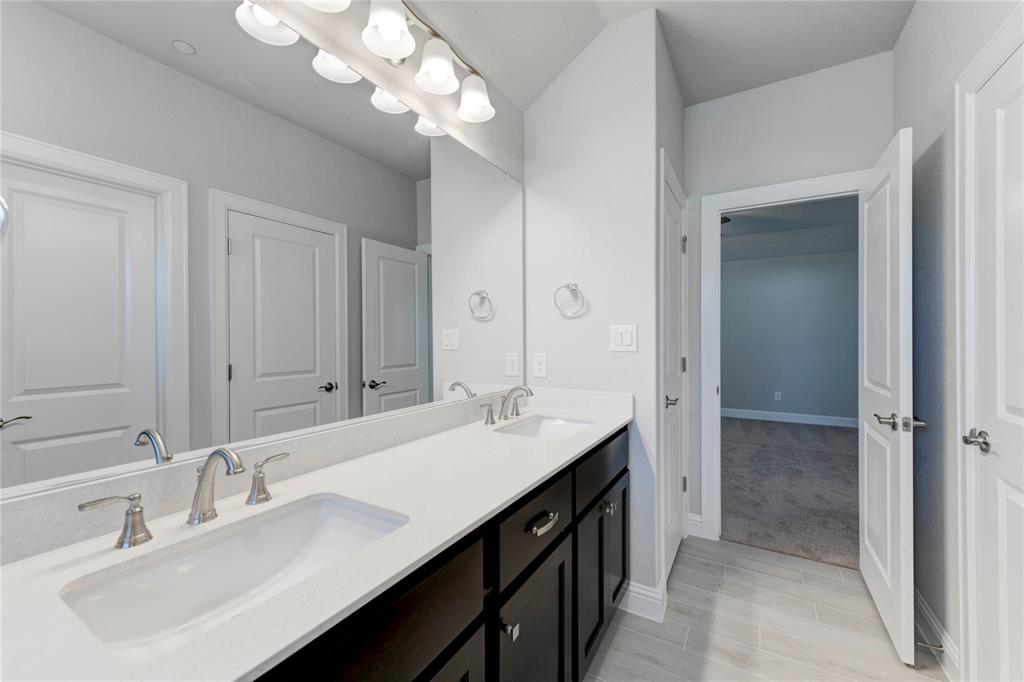 2605 Sam Bass Road, Unit 91 Round Rock, TX 78681 - Photo 26 of 32 a bathroom with a sink double vanity and a mirror