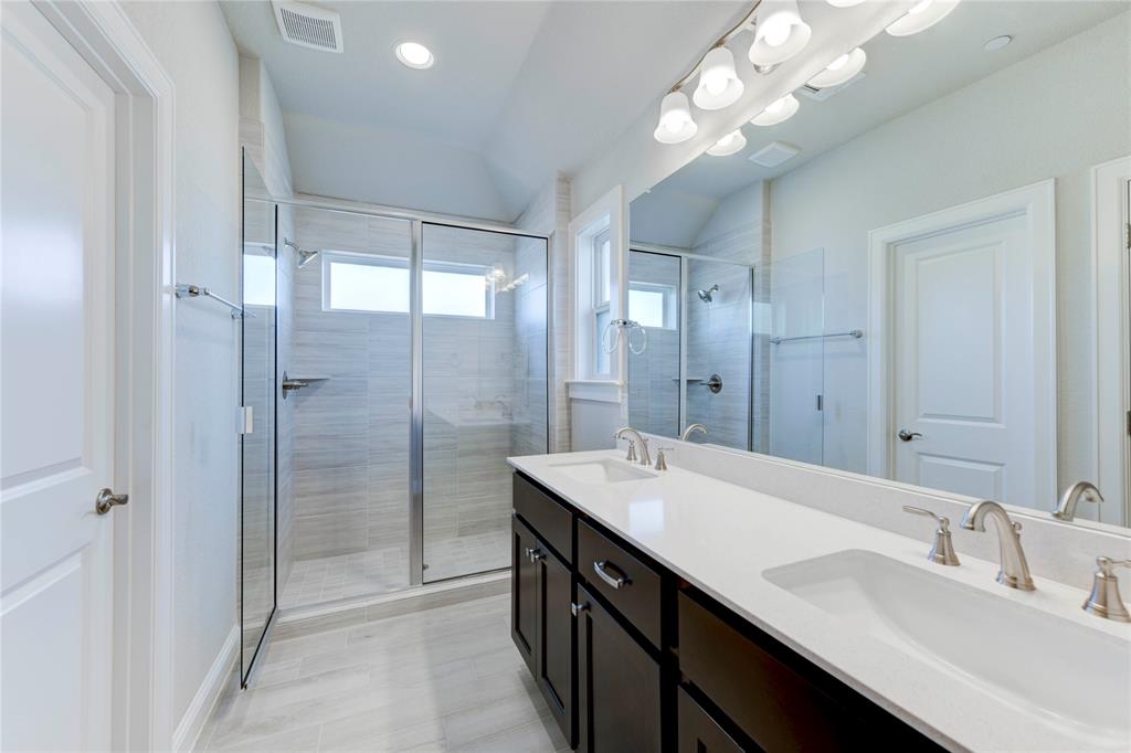 2605 Sam Bass Road, Unit 91 Round Rock, TX 78681 - Photo 27 of 32 a bathroom with a double vanity sink mirror and shower