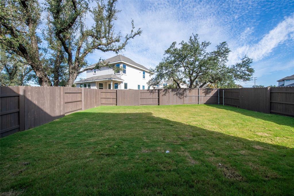 2605 Sam Bass Road, Unit 91 Round Rock, TX 78681 - Photo 29 of 32 a view of a backyard with a garden and tree