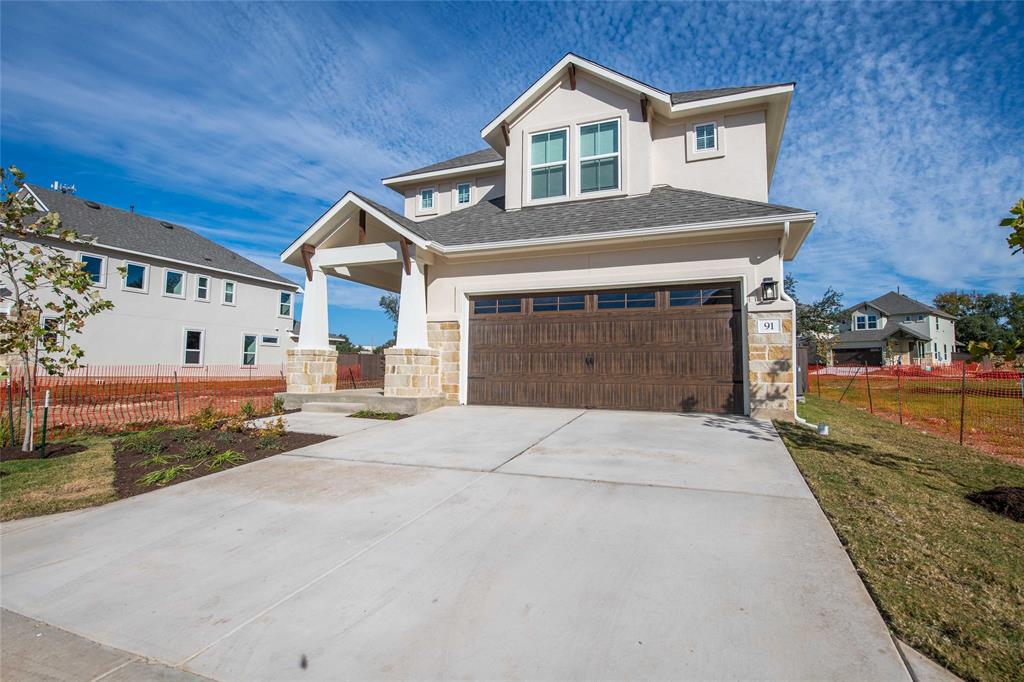 2605 Sam Bass Road, Unit 91 Round Rock, TX 78681 - Photo 4 of 32 a front view of a house with a yard and garage