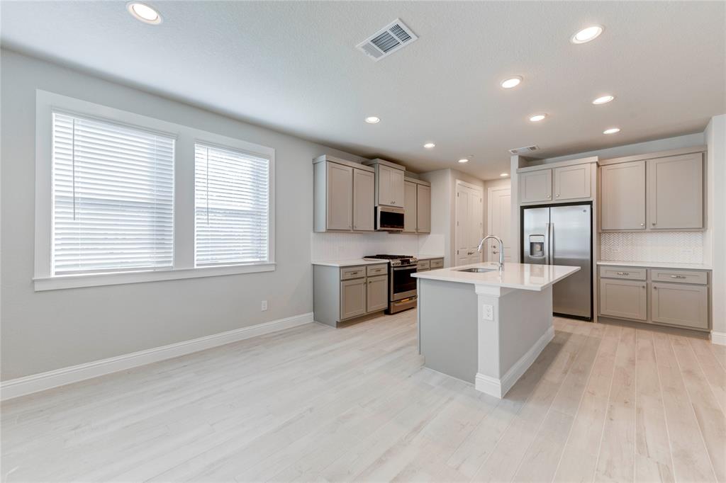2605 Sam Bass Road, Unit 91 Round Rock, TX 78681 - Photo 9 of 32 a kitchen with stove a sink and a refrigerator