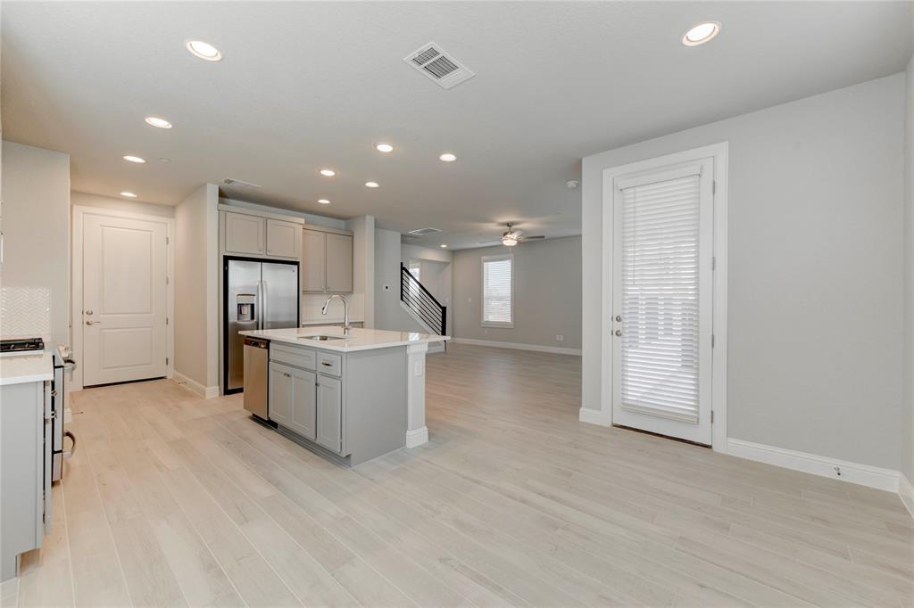 2605 Sam Bass Road, Unit 91 Round Rock, TX 78681 - Photo 10 of 32 a view of a kitchen with kitchen island wooden floors appliances