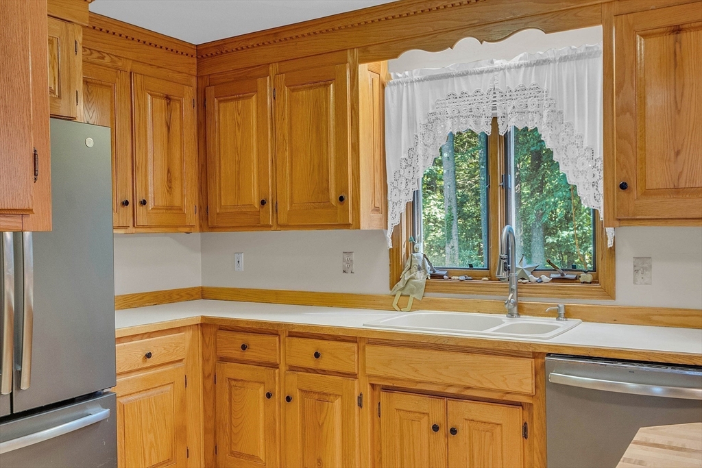 8 Ryan Road Townsend, MA 01474 - Photo 9 of 39 a kitchen with a window a sink and cabinets