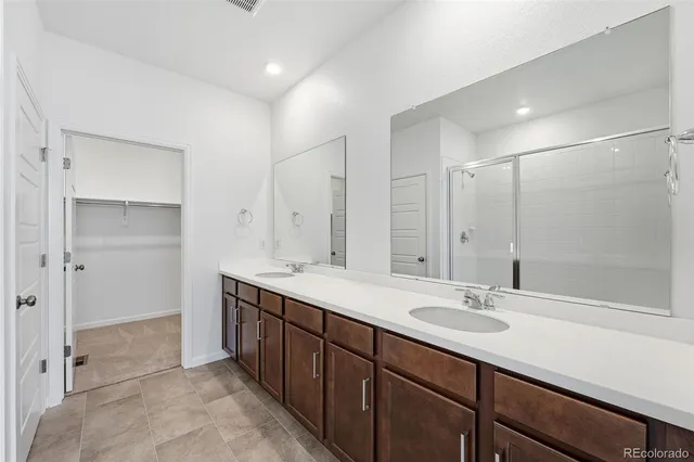 a bathroom with a sink double vanity and a mirror