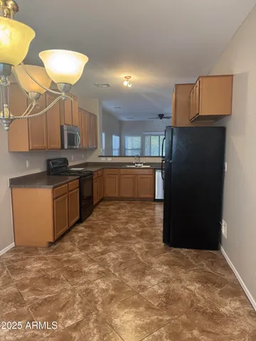 a view of a kitchen with a sink and cabinet