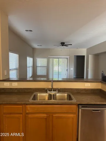 a kitchen with granite countertop a refrigerator stove and oven
