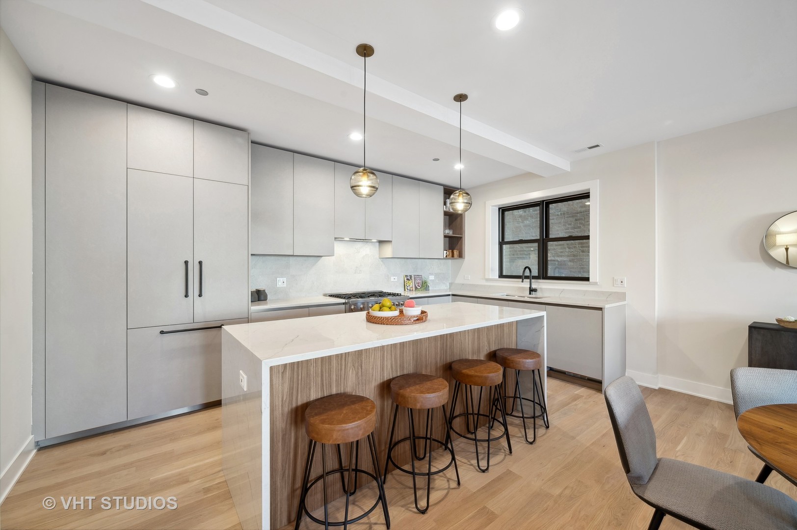 4537 North Clark Street, Unit 2D Chicago, IL 60640 - Photo 11 of 27 a kitchen with kitchen island a stove a table and chairs in it