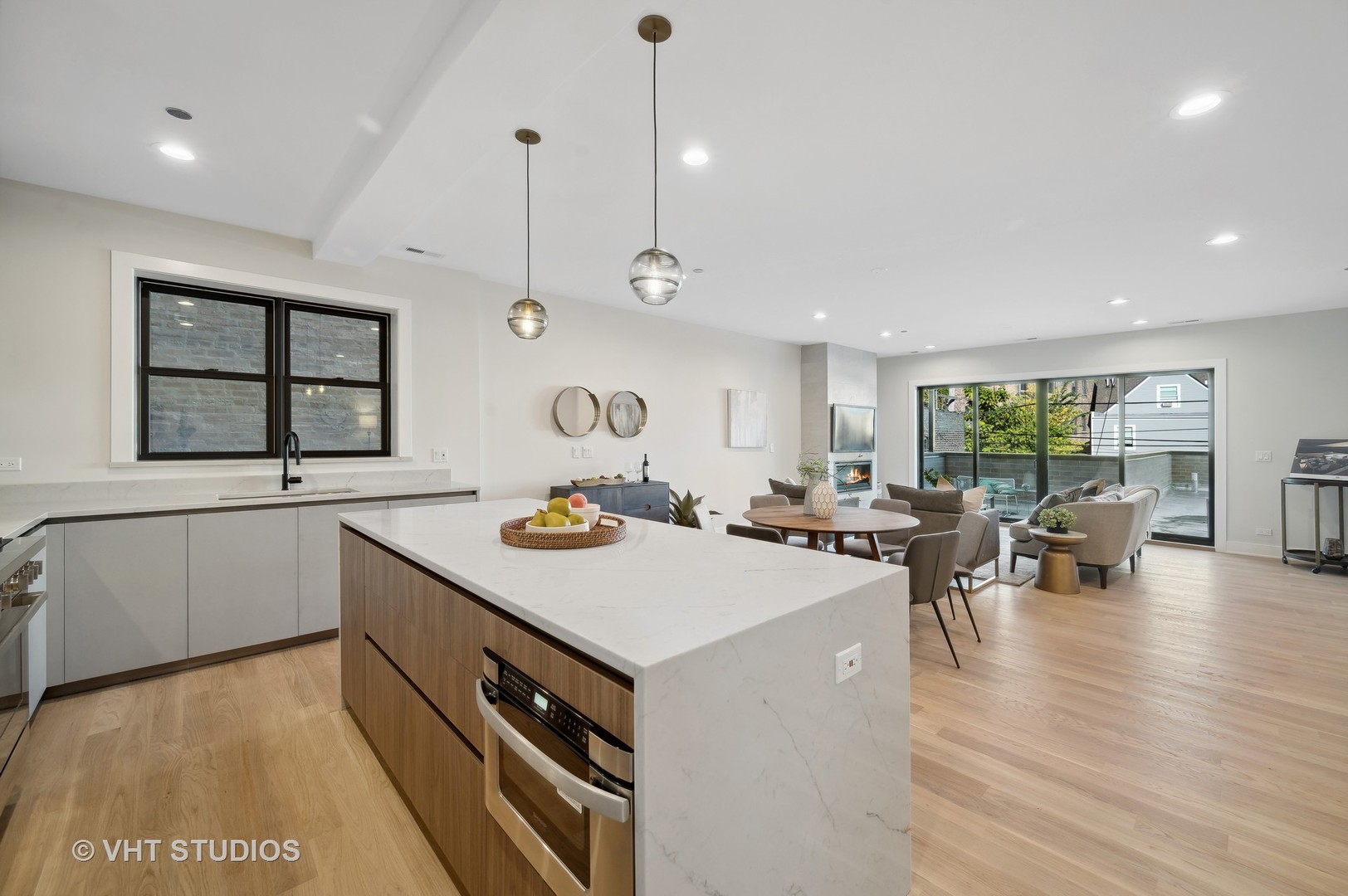 4537 North Clark Street, Unit 2D Chicago, IL 60640 - Photo 14 of 27 a view of a kitchen with kitchen island a stove a wooden floor and a large window