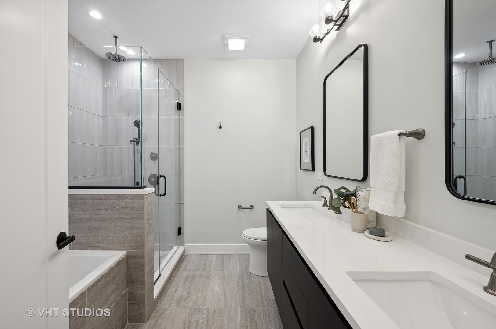 4537 North Clark Street, Unit 2D Chicago, IL 60640 - Photo 19 of 27 a bathroom with a double vanity sink a mirror and a shower