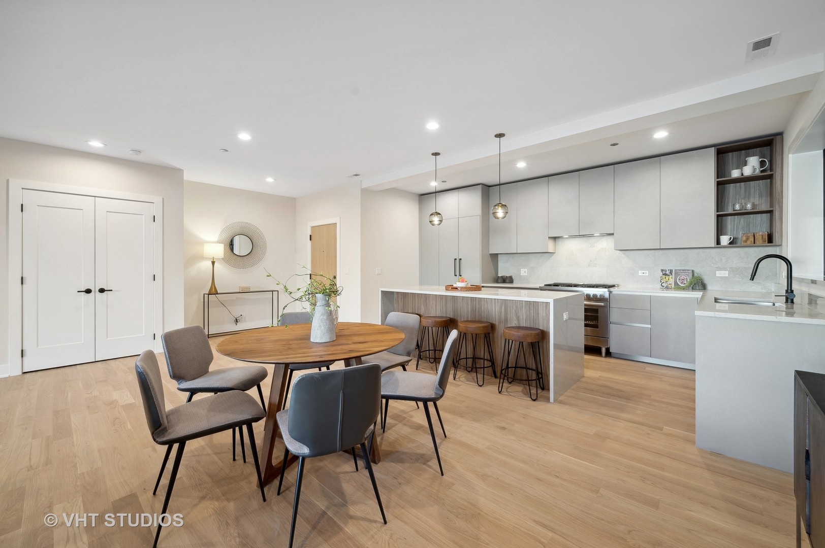 4537 North Clark Street, Unit 2D Chicago, IL 60640 - Photo 9 of 27 a kitchen with a dining table chairs wooden floor appliances and cabinets