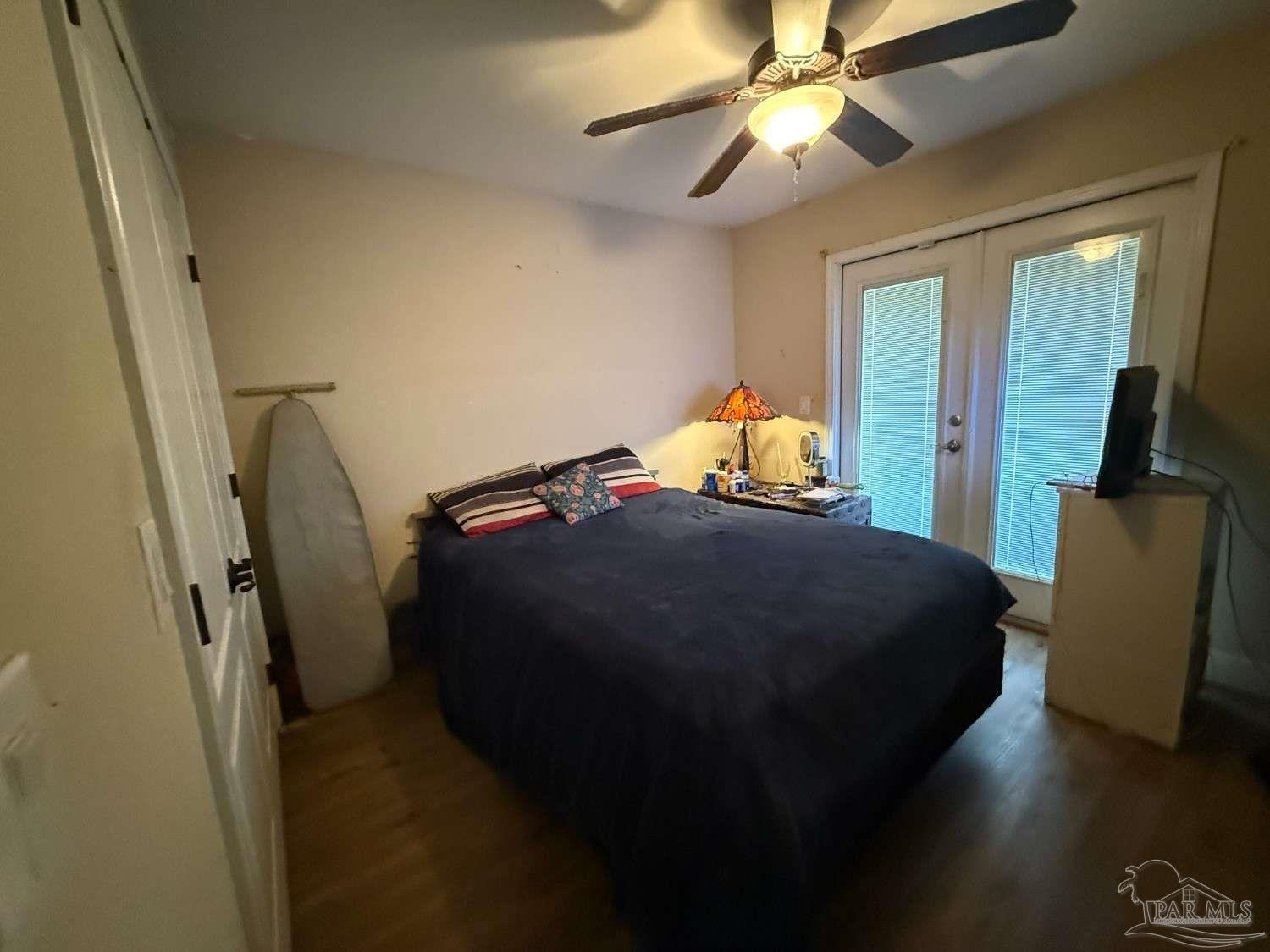 8826 Bluebell Street Milton, FL 32583 - Photo 15 of 25 a bedroom with a bed and a chandelier