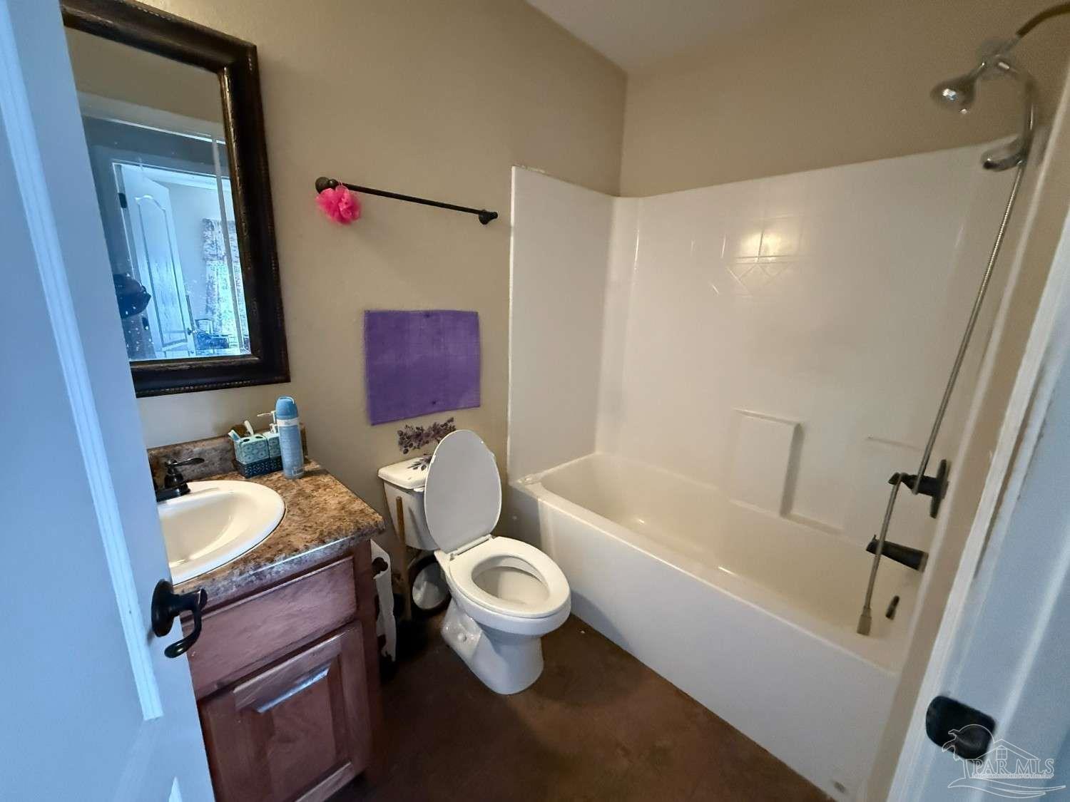 8826 Bluebell Street Milton, FL 32583 - Photo 18 of 25 a bathroom with a granite countertop toilet sink and tub