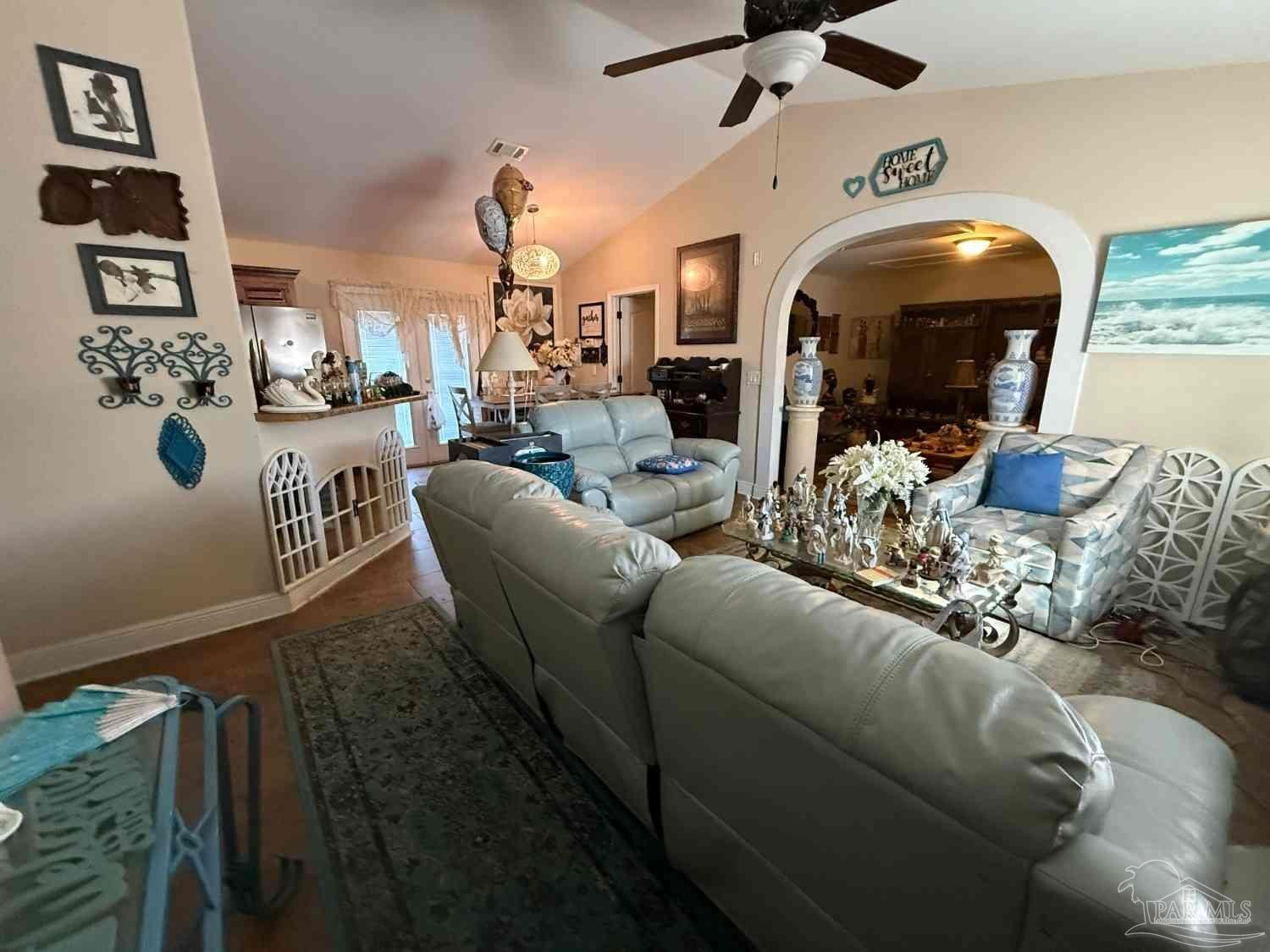 8826 Bluebell Street Milton, FL 32583 - Photo 20 of 25 a living room with furniture and chandelier