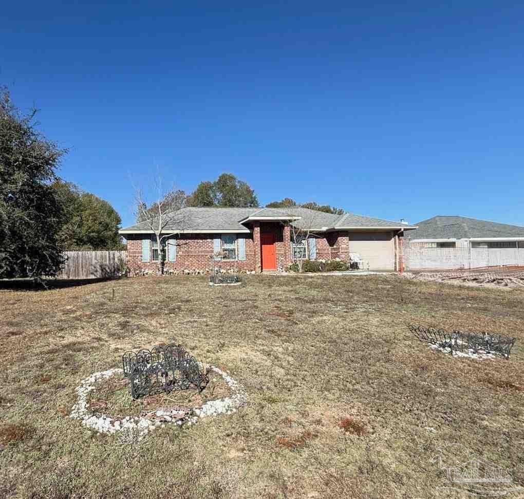 8826 Bluebell Street Milton, FL 32583 - Photo 2 of 25 a front view of a house with a yard