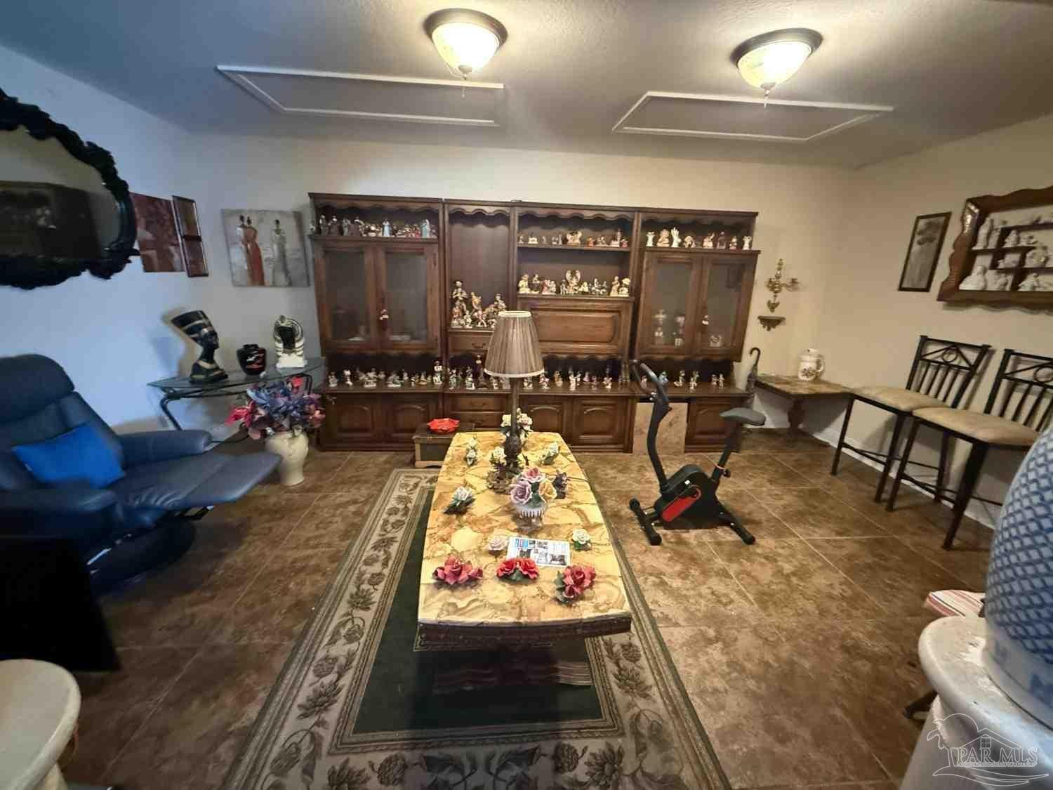 8826 Bluebell Street Milton, FL 32583 - Photo 21 of 25 a living room with furniture and a flat screen tv