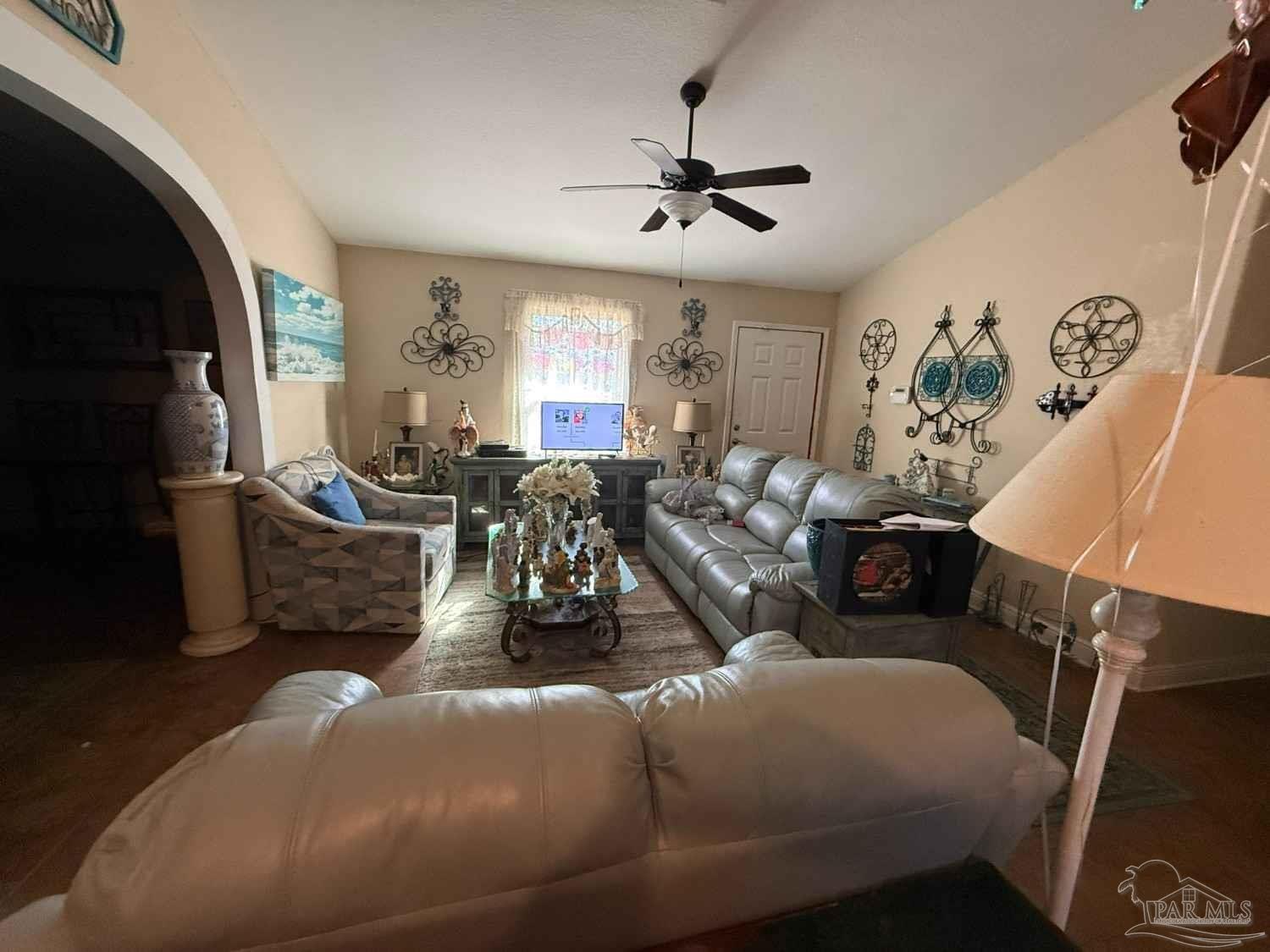 8826 Bluebell Street Milton, FL 32583 - Photo 24 of 25 a living room with furniture and a flat screen tv