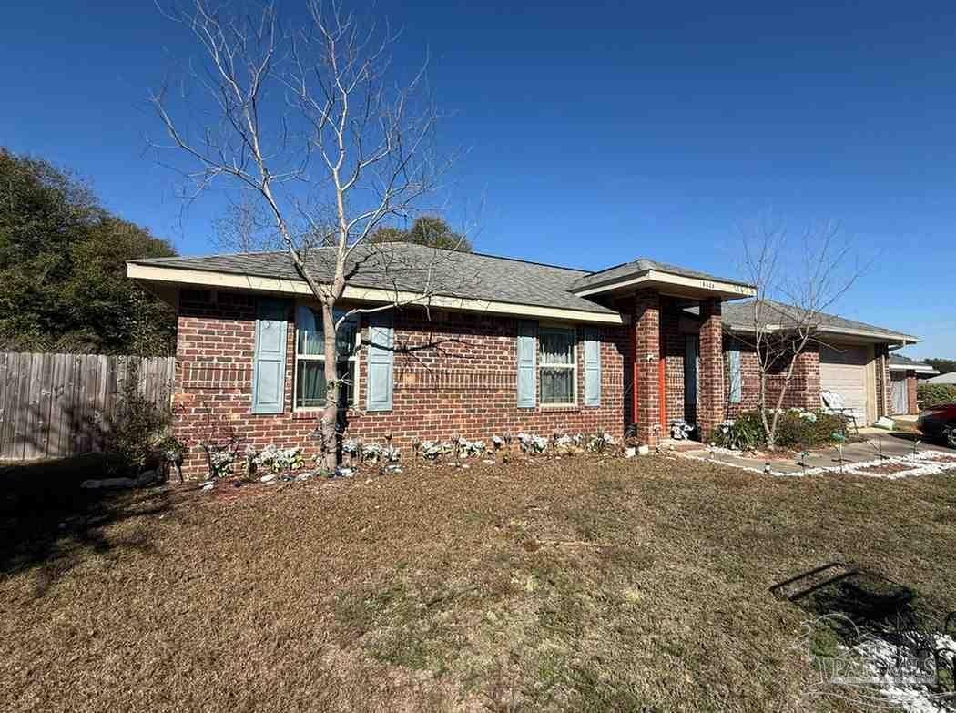 8826 Bluebell Street Milton, FL 32583 - Photo 3 of 25 a front view of a house with garden