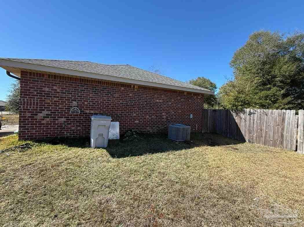 8826 Bluebell Street Milton, FL 32583 - Photo 5 of 25 a front view of a house with a yard