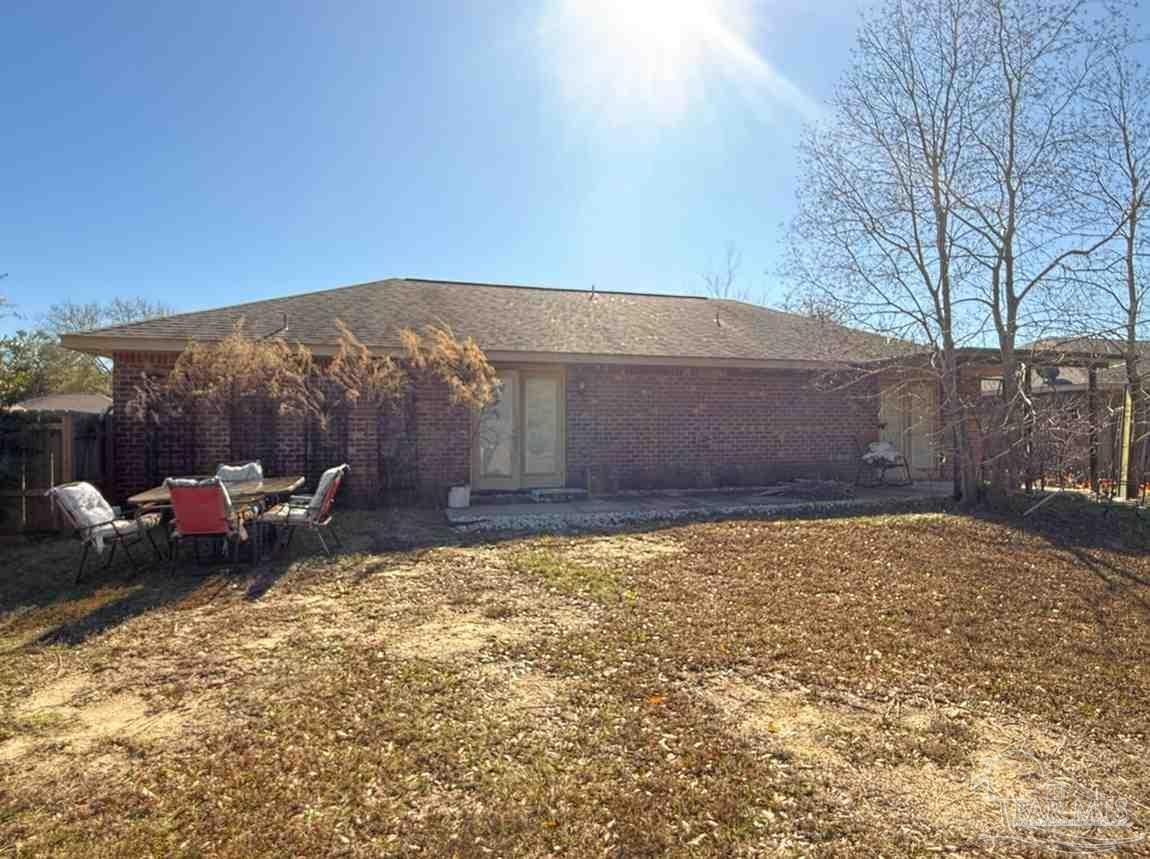 8826 Bluebell Street Milton, FL 32583 - Photo 8 of 25 a view of a backyard with a bench