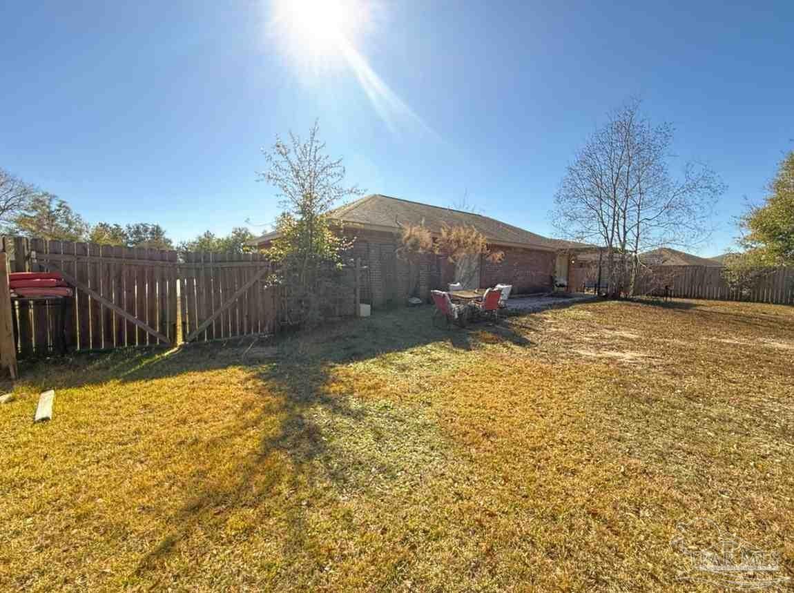 8826 Bluebell Street Milton, FL 32583 - Photo 10 of 25 a view of a backyard of the house