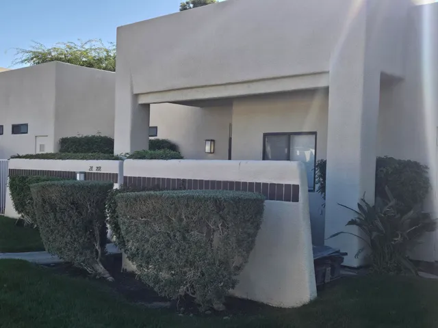 a bedroom with a bed and a potted plant