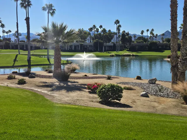 a lake with houses in the back
