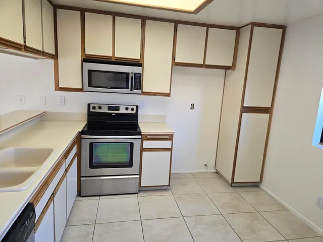 a kitchen with a stove microwave and sink