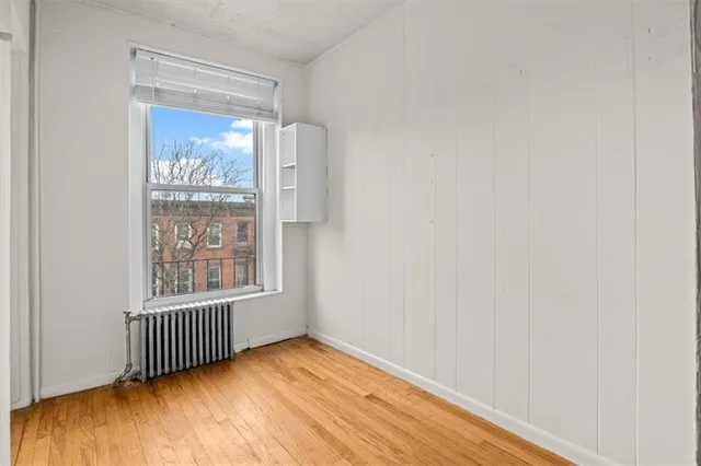 a front view of a building with lot of cars parked