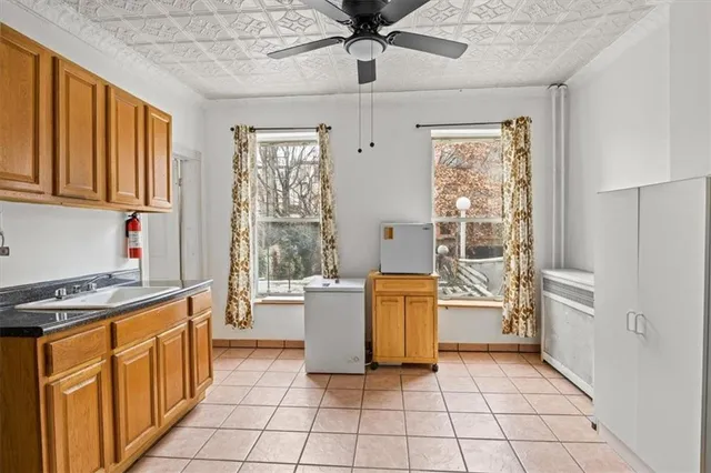 a view of a workspace with furniture and a window