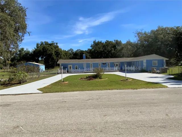 a view of a swimming pool with a patio and a garden