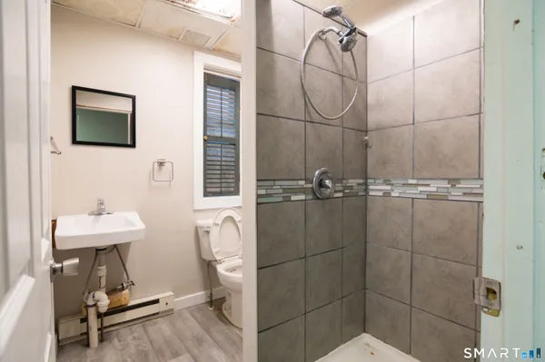 a bathroom with a sink a toilet and mirror