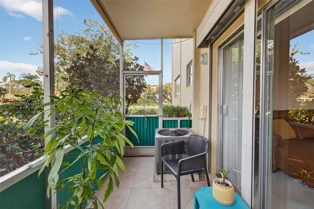a view of balcony with furniture and garden