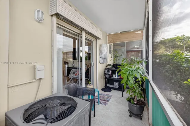 a kitchen with a potted plant on the counter and a glass door