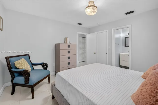 a bedroom with a bed and chair