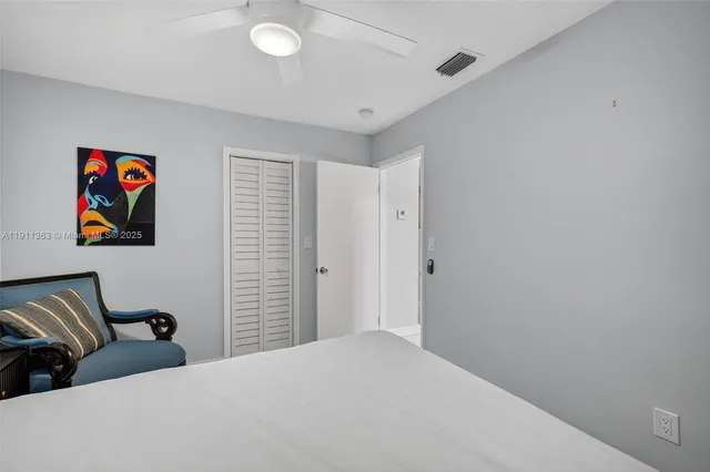 a bedroom with a bed and a book shelf