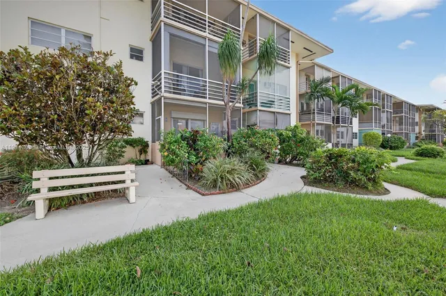 a view of a house with a yard and sitting area