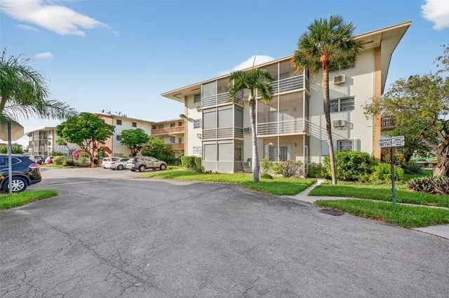 a view of a house with a yard and plants