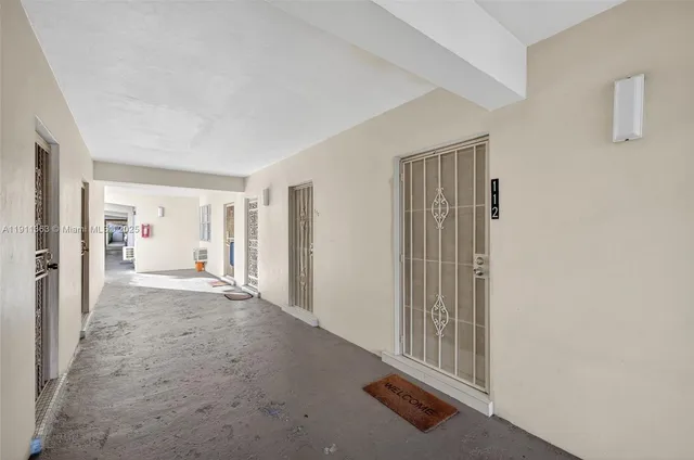 a view of a hallway with wooden shelves