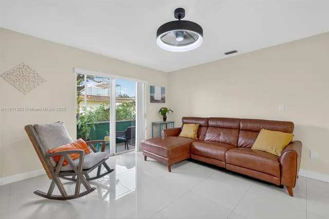 a living room with furniture and a floor to ceiling window