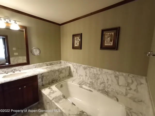 a bedroom with a bed and a mirror