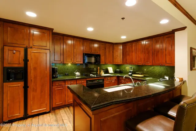 a kitchen with a sink appliances and cabinets