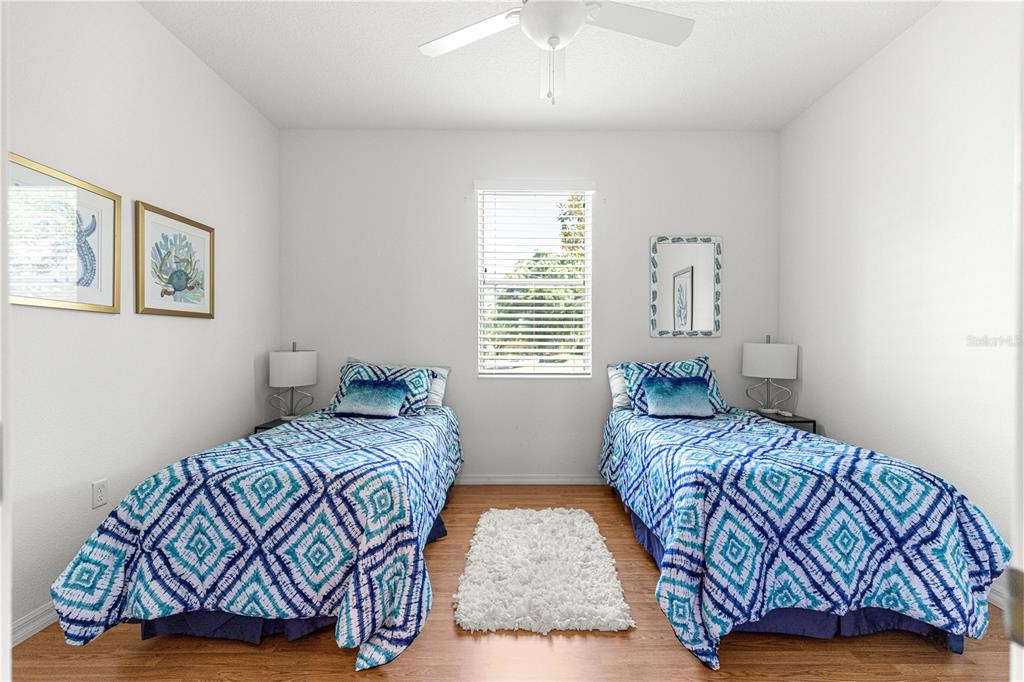 9317 Southwest 94th Loop Ocala, FL 34481 - Photo 24 of 40 a bedroom with a bed and a painting on the wall