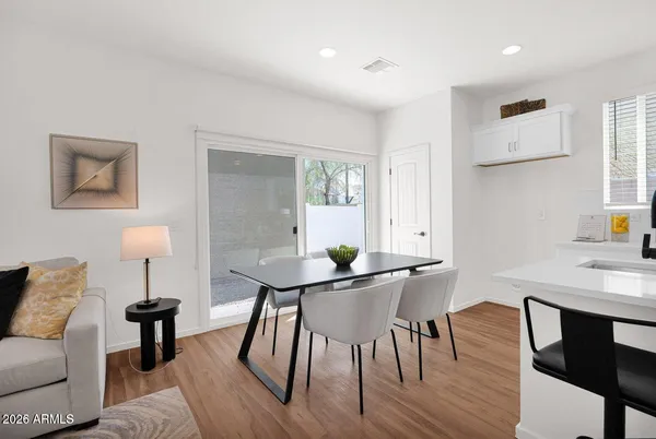 a view of a dining room with furniture and wooden floor