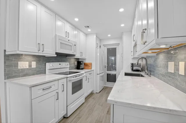 a bedroom with two beds and a chair