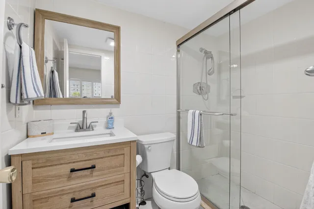 a view of a hallway with dining area and chandelier