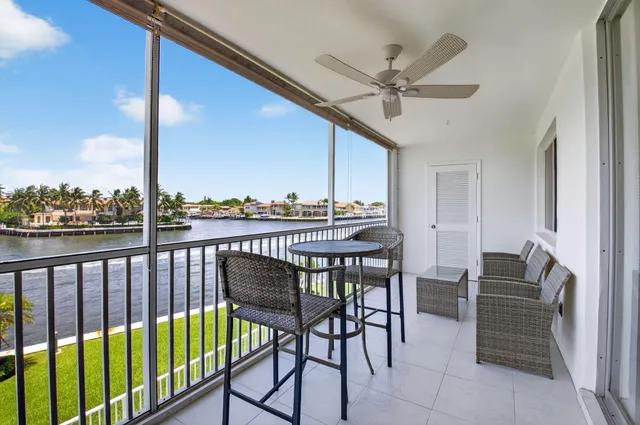 a view of a chairs and table in patio with a wooden fence