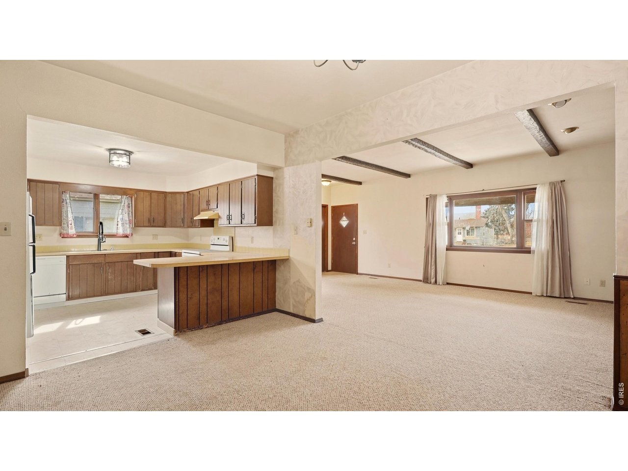 914 Prospect Street Fort Morgan, CO 80701 - Photo 5 of 17 a open kitchen with a sink window and cabinets